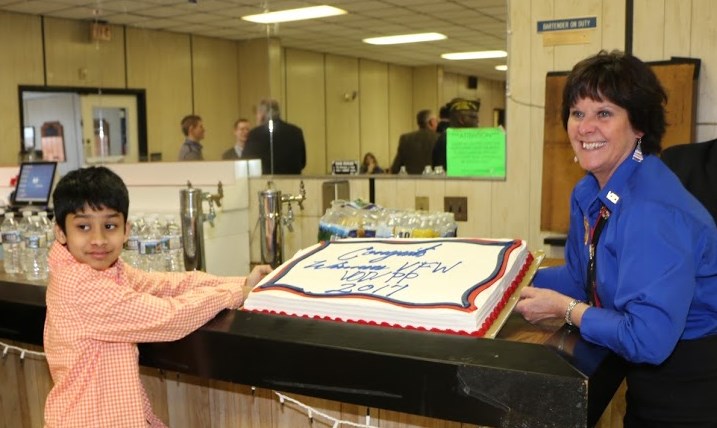 Patriot's Pen winner and Auxiliary President showing off cake in his honor.